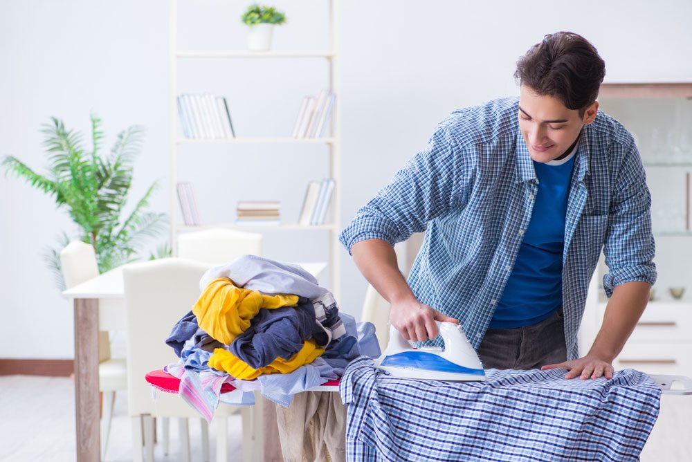Sober Summer man ironing clothes before sober vacation