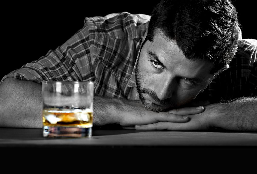 Domestic Violence and Addiction sad man with an alcohol problem 