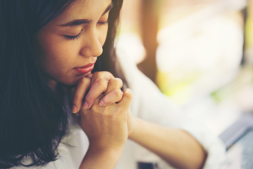 woman on her knees praying